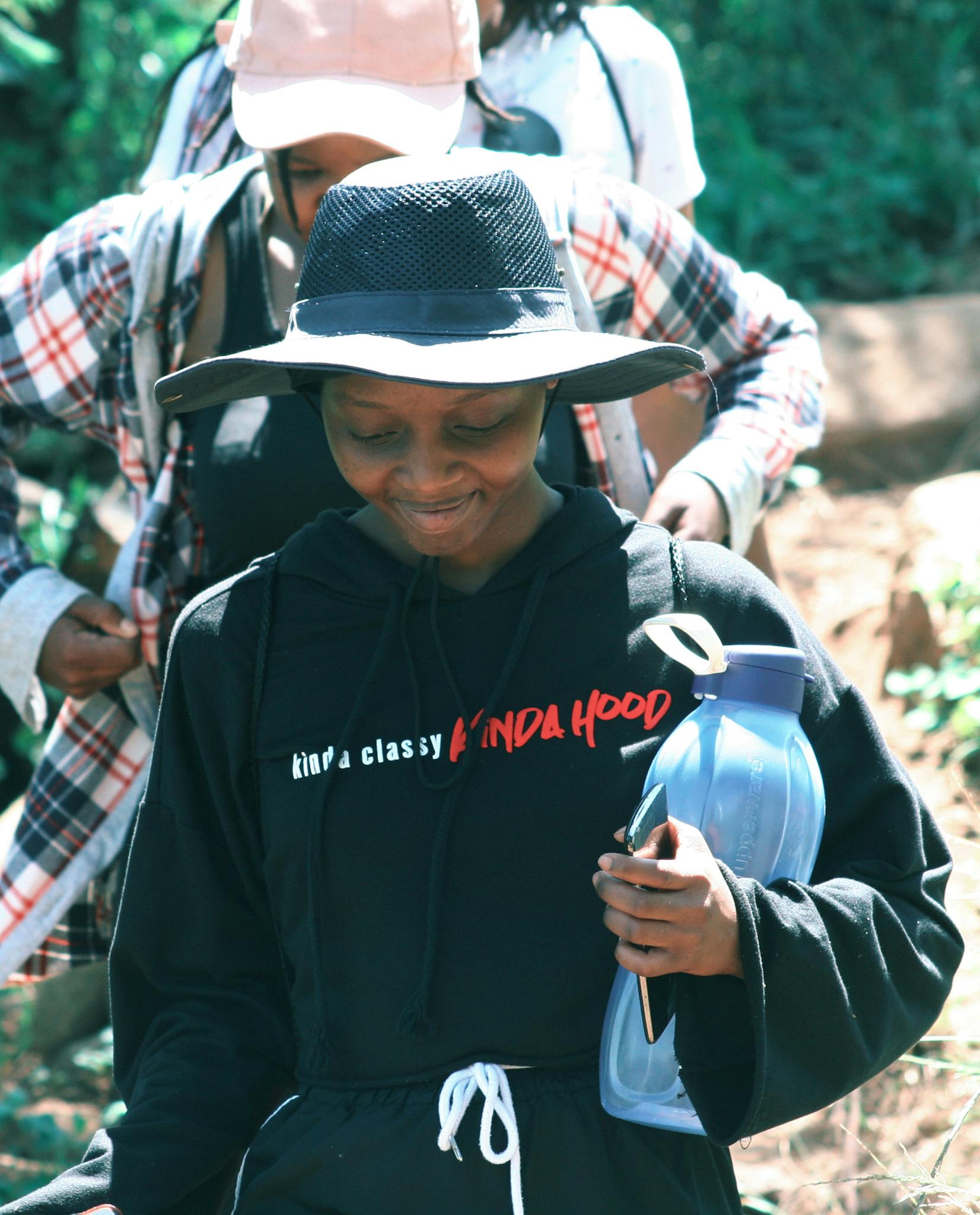 A group enjoying a hiking adventure in the vibrant greenery of Mbabane, Eswatini.